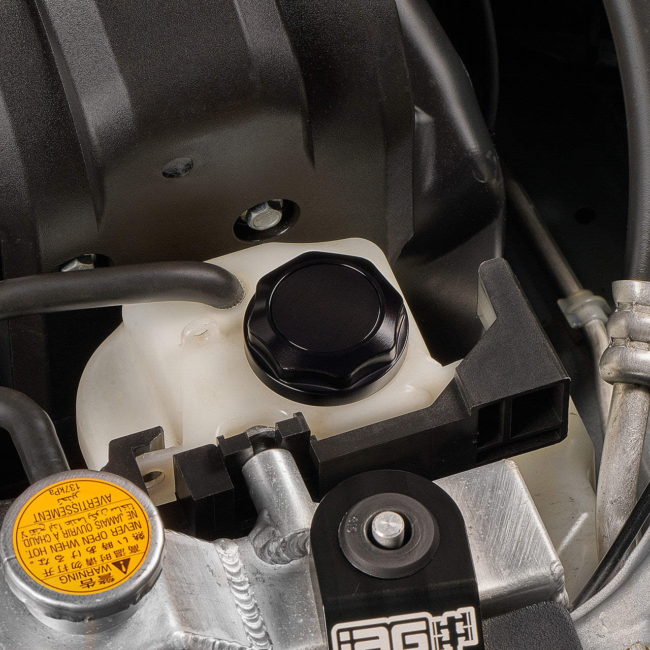 IAG Revolve Engine Bay Dress-Up Cap Kit for 15-21 STI - Black Coolant Cap Install Close-up 2